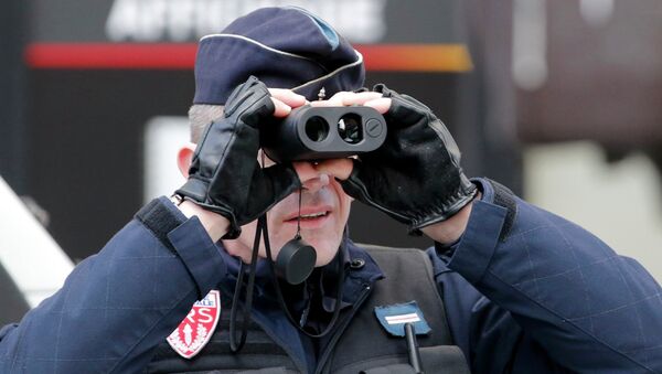 A policeman uses binoculars as he secures the hundreds of thousands of French citizens solidarity march - Sputnik International
