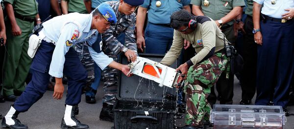 The flight data recorder of AirAsia QZ8501 is transferred to another container at the airbase in Pangkalan Bun, Central Kalimantan January 12, 2015. The flight data recorder of AirAsia QZ8501 is transferred to another container at the airbase in Pangkalan Bun, Central Kalimantan January 12, 2015. - Sputnik International