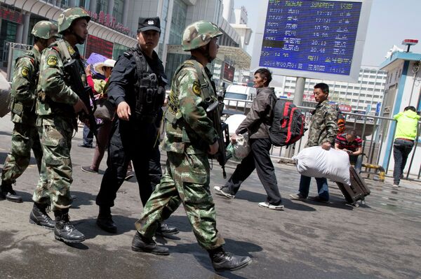Armed Chinese paramilitary policemen march past the site of the explosion outside the Urumqi South Railway Station in Urumqi in northwest China's Xinjiang Uygur Autonomous Region, 2015. Armed Chinese paramilitary policemen march past the site of the explosion outside the Urumqi South Railway Station in Urumqi in northwest China's Xinjiang Uygur Autonomous Region, 2015. - Sputnik International