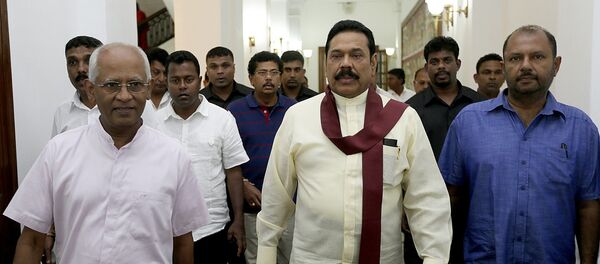 In this hand out photograph received from the President’s Office on January 9, 2015 outgoing president Mahinda Rajapakse (C) leaves his office in the capital Colombo In this hand out photograph received from the President’s Office on January 9, 2015 outgoing president Mahinda Rajapakse (C) leaves his office in the capital Colombo - Sputnik International