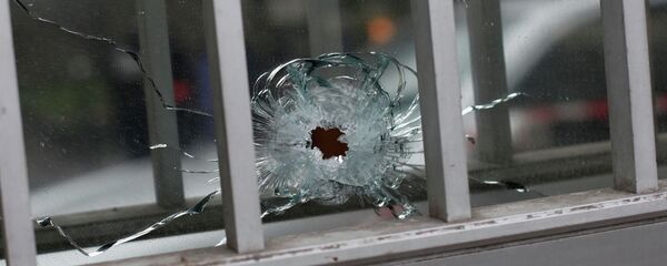 A bullet impact is seen in a window - Sputnik International
