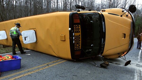 A North Carolina Highway Patrol officer works the scene after a Gaston County school bus overturned in Gastonia, N.C. Wednesday, Jan. 14, 2015 - Sputnik International