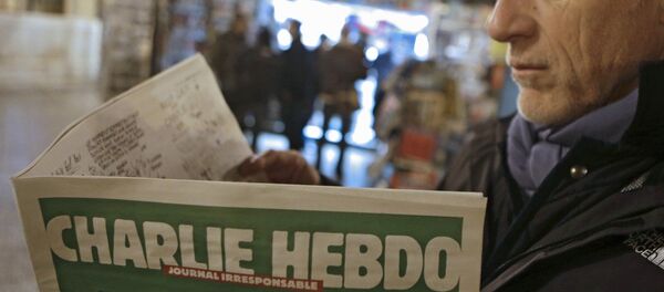 Jean Paul Bierlein reads the new Charlie Hebdo outside a newsstand in Nice, southeastern France, Wednesday, Jan. 14, 2015. - Sputnik International