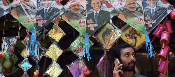 An Indian shopkeeper talks on his mobile phone below kites with images of Indian prime minister Narendra Modi (L) and US President Barack Obama (R) in Mumbai on January 7, 2015 An Indian shopkeeper talks on his mobile phone below kites with images of Indian prime minister Narendra Modi (L) and US President Barack Obama (R) in Mumbai on January 7, 2015 - Sputnik International
