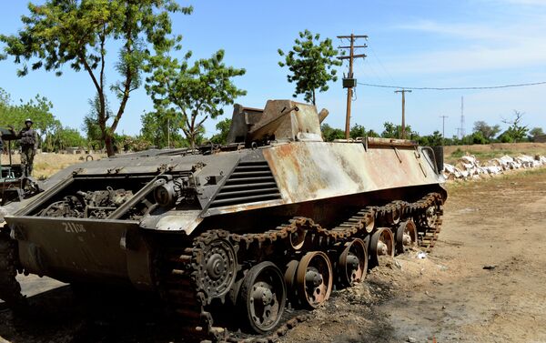 This picture taken on November 12, 2014 in front of the military base of Amchide, northern Cameroon, 1 km from Nigeria, shows a Boko Haram's tank destroyed by Cameroonian soldiers during an attack againts the military base by the Islamic fighters on October 15, 2014. - Sputnik International
