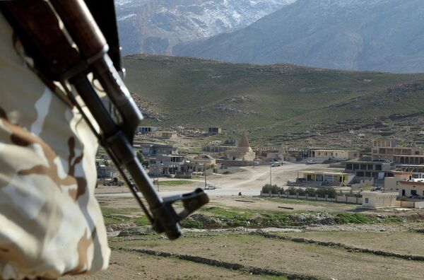 In this Sunday Jan. 11, 2015 photo, a Yazidi fighter protects the Sharaf al-Deen temple shrine, one of the holiest for the Yazidis, a religious minority whom the Islamic State group considers heretics ripe for slaughter, in Sinjar, northern Iraq - Sputnik International