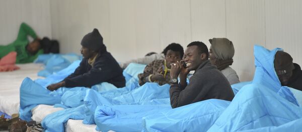 Migrants bed down for the night at a warehouse in Calais, northern France Migrants bed down for the night at a warehouse in Calais, northern France - Sputnik International