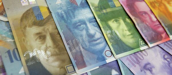 Various Swiss Franc notes lay on a table in this file picture illustration at a bank in Warsaw, July 18, 2011 Various Swiss Franc notes lay on a table in this file picture illustration at a bank in Warsaw, July 18, 2011 - Sputnik International