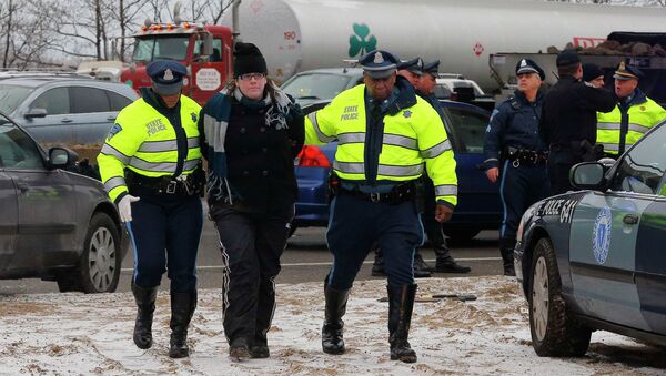 Police detain a protester who was part of a group who blocked Interstate 93 southbound during the morning rush hour in Somerville, Massachusetts January 15, 2015 - Sputnik International