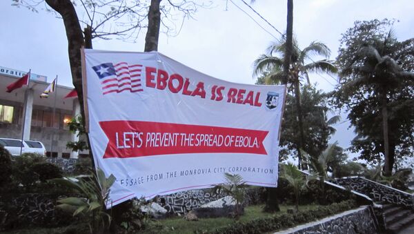 A banner reading 'Lets prevent the spread of Ebola, in front of the city hall in Monrovia, Liberia, Thursday, July 31, 2014 - Sputnik International