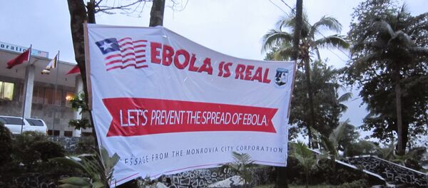 A banner reading 'Lets prevent the spread of Ebola, in front of the city hall in Monrovia, Liberia, Thursday, July 31, 2014 - Sputnik International