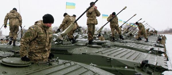 Ukrainian servicemen get inside armoured personnel carriers (APC) during a ceremony to hand over weapons, military equipment and aircraft to the army at a firing range outside Zhytomyr January 5, 2015 - Sputnik International