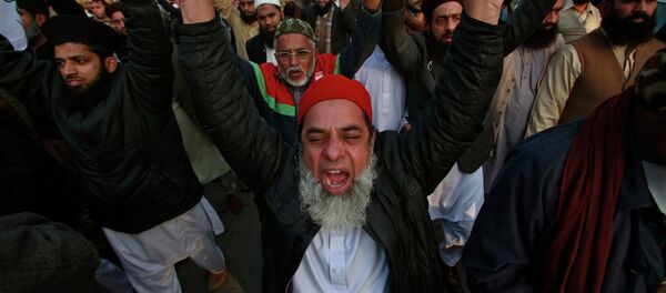 People chant slogans as they hold signs during a protest against satirical French weekly newspaper Charlie Hebdo People chant slogans as they hold signs during a protest against satirical French weekly newspaper Charlie Hebdo - Sputnik International