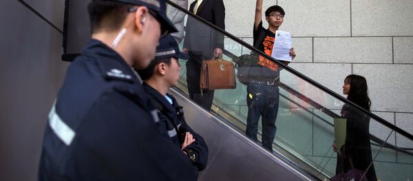 Hong Kong student leader Joshua Wong, 18, gestures to supporters as he arrives at the police headquarters in Hong Kong January 16, 2015 - Sputnik International