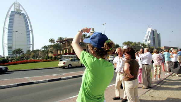Tourists take pictures of the Burj al-Arab (L) and Jumeirah Beach Hotel in Dubai - Sputnik International