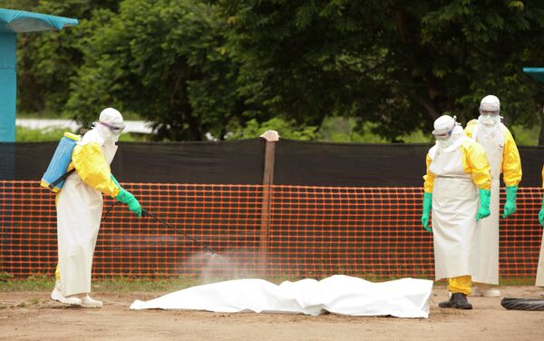 Medical workers are disinfecting the dead body of an Ebola patient. - Sputnik International