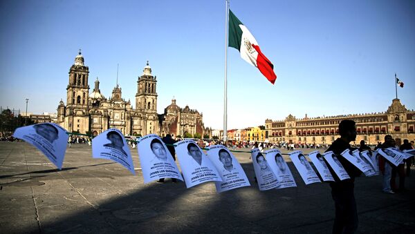 Leaflets with the images of 43 missing students from the state of Guerrero, are shown before a massive protest march, at the Zocalo in Mexico City - Sputnik International