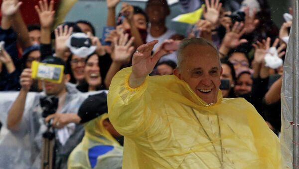 Pope Francis smiles as he waves to residents during a motorcade in Tacloban city, after holding a mass near the airport, January 17, 2015 - Sputnik International