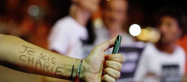 A woman holding a pen shows her arm covered with the words in French I am Charlie A woman holding a pen shows her arm covered with the words in French I am Charlie - Sputnik International