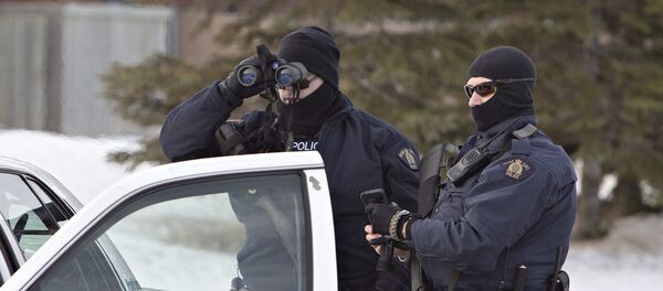 Police search for a suspect in the shooting of two RCMP officers in St. Albert, Alberta, Canada, on Saturday, Jan. 17, 2015 Police search for a suspect in the shooting of two RCMP officers in St. Albert, Alberta, Canada, on Saturday, Jan. 17, 2015 - Sputnik International