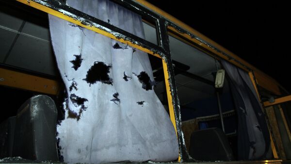A view of the shattered windows and the torn curtains of a bus hit during shelling apparently aimed at a checkpoint manned by Ukrainian forces in Volnovakha, in the eastern Donetsk region, on January 13, 2015 - Sputnik International