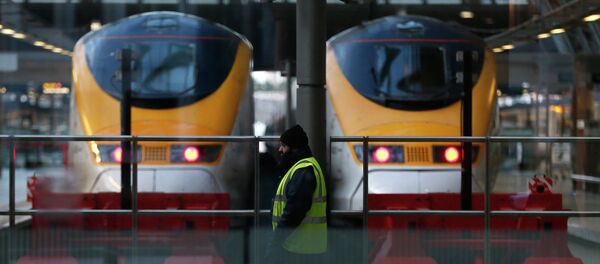 A worker walks past high speed trains at St Pancras International Station in London A worker walks past high speed trains at St Pancras International Station in London - Sputnik International