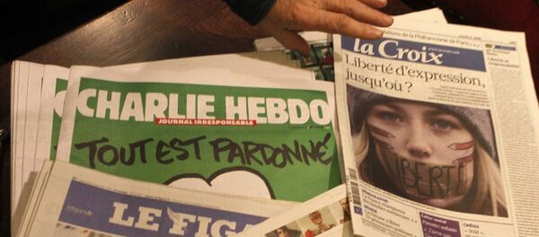 Copies of the latest issue of Charlie Hebdo newspaper are sold with other newspapers at a newsstand in Lille, northern France - Sputnik International