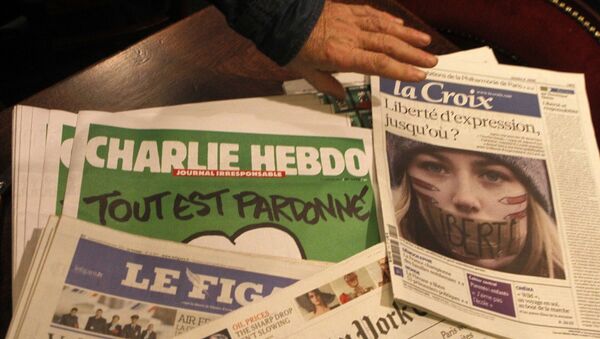 Copies of the latest issue of Charlie Hebdo newspaper are sold with other newspapers at a newsstand in Lille, northern France - Sputnik International