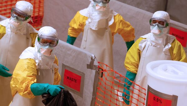 Medical workers wearing protective suits take part in a training prior to leave to countries affected by the Ebolas virus, in an empty factory warehouse in Amsterdam - Sputnik International