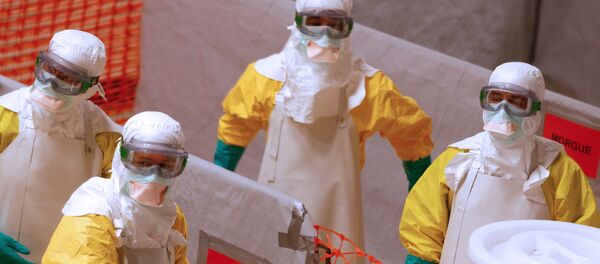 Medical workers wearing protective suits take part in a training prior to leave to countries affected by the Ebolas virus, in an empty factory warehouse in Amsterdam - Sputnik International