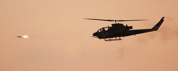 A 'Viper' attack helicopter launches a missile toward a marked target A 'Viper' attack helicopter launches a missile toward a marked target - Sputnik International