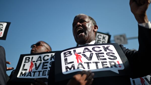 Men holding signs reading Black Lives Matter march in the 30th annual Kingdom Day Parade in honor of Dr. Martin Luther King Jr. - Sputnik International