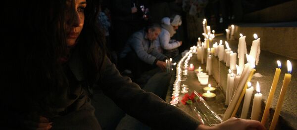 A woman lights a candle in the center of Yerevan on late January 13, 2015 in tribute to the six members of the same family allegedly killed by Russian soldier Valery Permyakov in the Armenian city of Gyumri A woman lights a candle in the center of Yerevan on late January 13, 2015 in tribute to the six members of the same family allegedly killed by Russian soldier Valery Permyakov in the Armenian city of Gyumri - Sputnik International