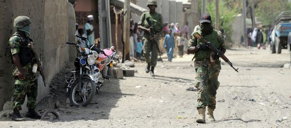 Soldiers walk in the street in the remote northeast town of Baga, Borno State. Soldiers walk in the street in the remote northeast town of Baga, Borno State. - Sputnik International