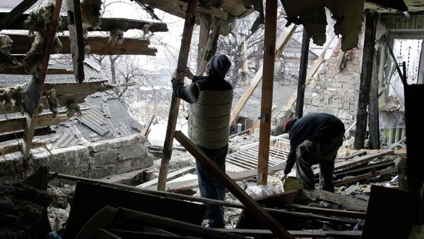 Local residents remove debris at a house damaged by recent shelling in Donetsk, eastern Ukraine, January 21, 2015 - Sputnik International