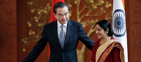 Indian External Affairs Minister Sushma Swaraj, right, and her Chinese counterpart, Wang Yi, leave for a meeting after a photo session in New Delhi, India, Sunday, June 8, 2014 Indian External Affairs Minister Sushma Swaraj, right, and her Chinese counterpart, Wang Yi, leave for a meeting after a photo session in New Delhi, India, Sunday, June 8, 2014 - Sputnik International