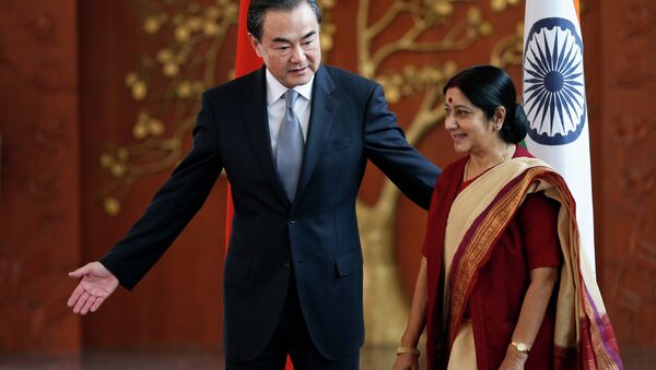 Indian External Affairs Minister Sushma Swaraj, right, and her Chinese counterpart, Wang Yi, leave for a meeting after a photo session in New Delhi, India, Sunday, June 8, 2014 - Sputnik International