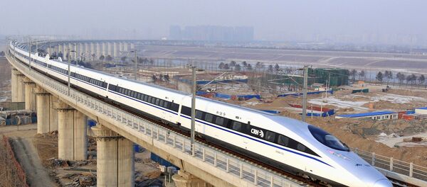 In this photo released by China's Xinhua news agency, a bullet train passes over Yongdinghe Bridge in Beijing Wednesday, Dec. 26, 2012 - Sputnik International