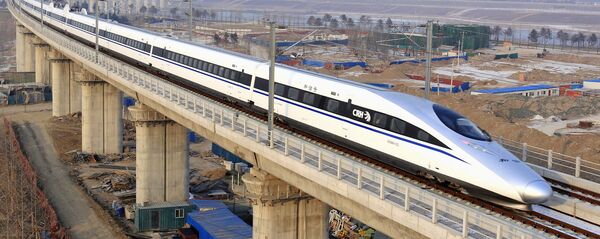 In this photo released by China's Xinhua news agency, a bullet train passes over Yongdinghe Bridge in Beijing Wednesday, Dec. 26, 2012 In this photo released by China's Xinhua news agency, a bullet train passes over Yongdinghe Bridge in Beijing Wednesday, Dec. 26, 2012 - Sputnik International
