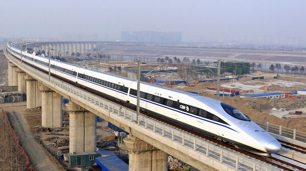 In this photo released by China's Xinhua news agency, a bullet train passes over Yongdinghe Bridge in Beijing Wednesday, Dec. 26, 2012 - Sputnik International