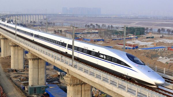 In this photo released by China's Xinhua news agency, a bullet train passes over Yongdinghe Bridge in Beijing Wednesday, Dec. 26, 2012 - Sputnik International