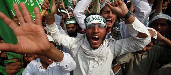 Supporters of religious group Sunni Tehreek chant slogans in a protest against satirical French weekly newspaper Charlie Hebdo, which featured a cartoon of the Prophet Mohammad as the cover of its first edition since an attack by Islamist gunmen, in Karachi January 22, 2015 Supporters of religious group Sunni Tehreek chant slogans in a protest against satirical French weekly newspaper Charlie Hebdo, which featured a cartoon of the Prophet Mohammad as the cover of its first edition since an attack by Islamist gunmen, in Karachi January 22, 2015 - Sputnik International