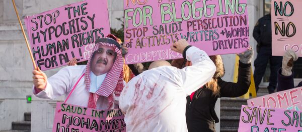 Protesters simulate a flogging in front of the Saudi embassy in Washington,DC on January 15, 2015 during a demonstration against the 10-year prison sentence and 1,000 lashes of Saudi activist Raef Badawi for insulting Islam in a blogpost - Sputnik International