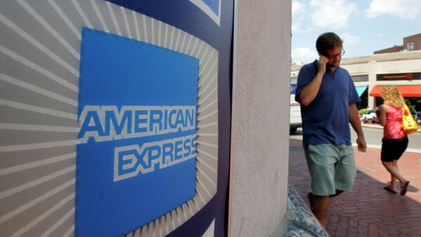 In this July 19, 2011 file photo, passers-by walk past an American Express logo near the entrance to a bank in the Harvard Square neighborhood of Cambridge, Mass - Sputnik International