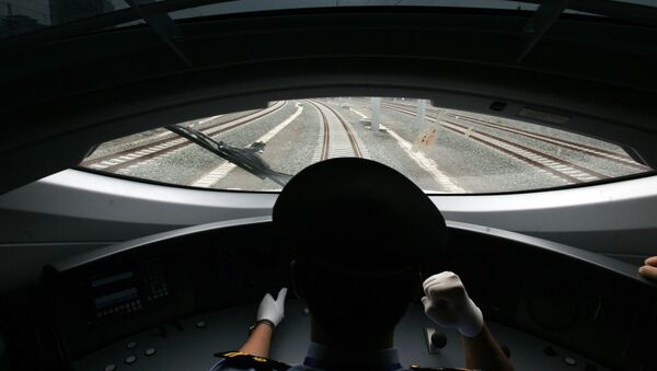 A Chinese train driver takes the new bullet train on a test run on the new high-speed Beijing-Tianjin express railway in Beijing on June 26, 2008 - Sputnik International