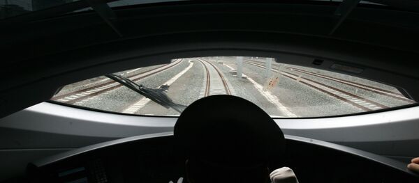 A Chinese train driver takes the new bullet train on a test run on the new high-speed Beijing-Tianjin express railway in Beijing on June 26, 2008 A Chinese train driver takes the new bullet train on a test run on the new high-speed Beijing-Tianjin express railway in Beijing on June 26, 2008 - Sputnik International