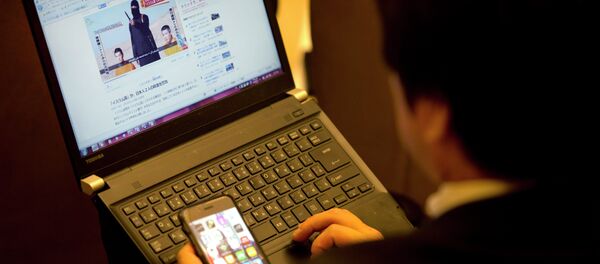 A Japanese journalist looks at a video of the hostages prior to Japan's Prime Minister Shinzo Abe press conference in Jerusalem, Tuesday, Jan. 20, 2015 - Sputnik International
