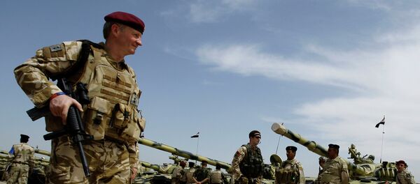 A British army soldier walks past Iraqi army tanks during a training mission in Latifiyah, 30 kilometers (20 miles) south of Baghdad, Iraq A British army soldier walks past Iraqi army tanks during a training mission in Latifiyah, 30 kilometers (20 miles) south of Baghdad, Iraq - Sputnik International