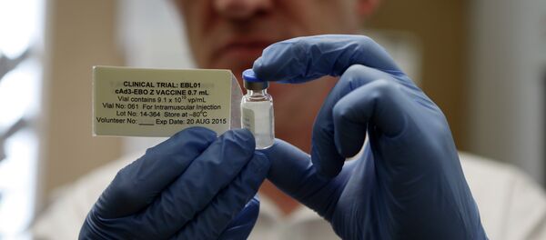 Professor Adrian Hill, director of the Jenner Institute and chief investigator of the trials with the Ebola vaccine Chimp Adenovirus type 3 (ChAd3), holds a vial of the vaccine - Sputnik International