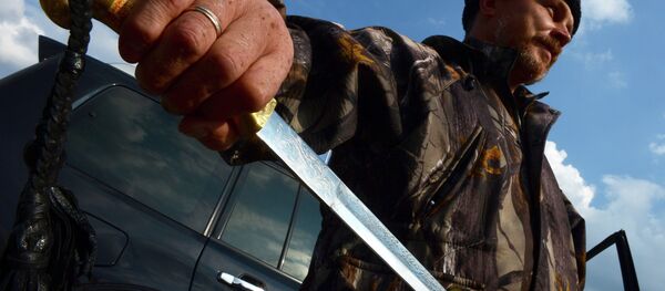 The mayor of Pervomaisk, a Cossack commander named Evgeniy, poses with his traditional sword in Pervomaisk, some 50 km west of Lugansk - Sputnik International
